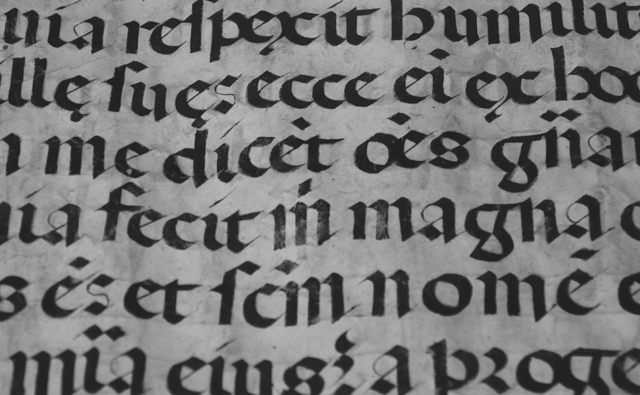 Detailed view of historical Gothic calligraphy on ancient parchment.